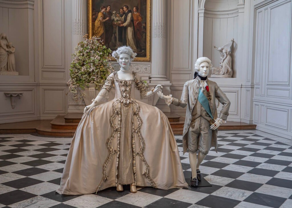 Wedding dress and suit costumes in the Petit Trianon at the 20th Anniversary Marie Antoinette by Sofia Coppola exhibition at Versailles
